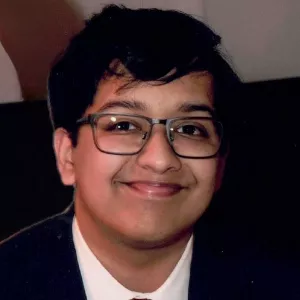 Paarangat Jain smiling in formal attire
